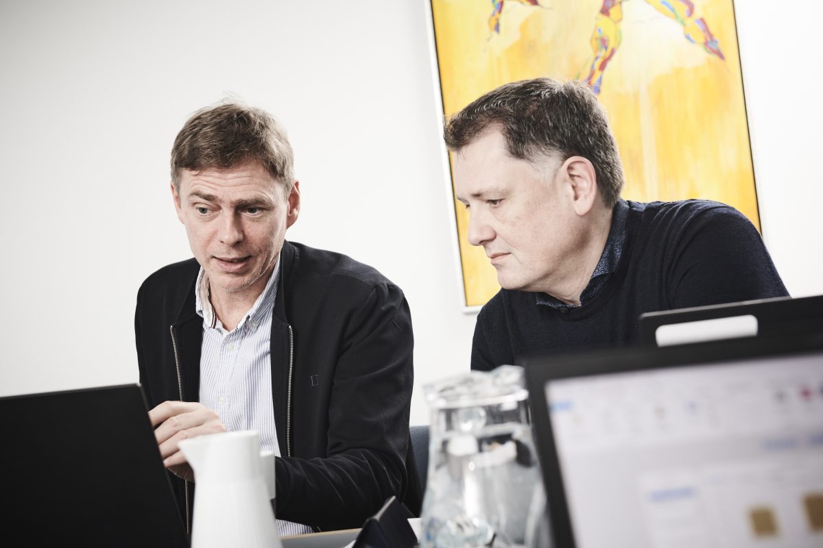18066 – 08 Et billede af to InfoSuite-medarbejdere foran en computerskærm.