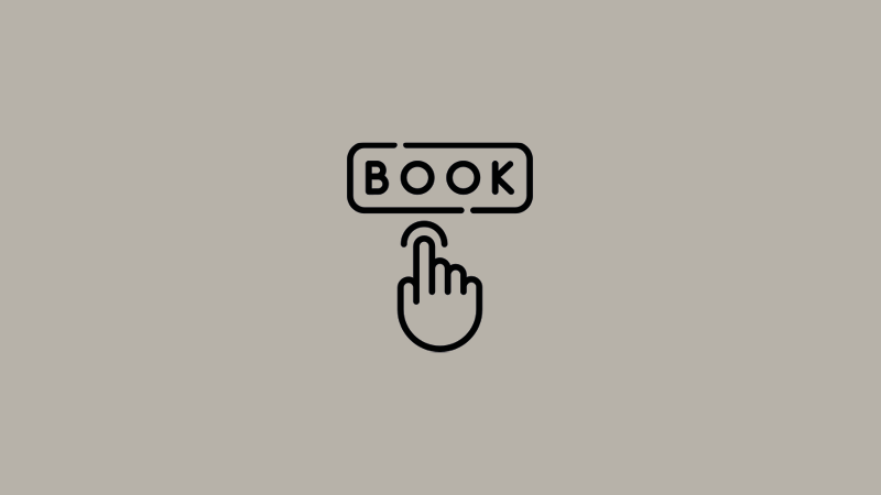 Et billede af en hånd der trykker Book 
